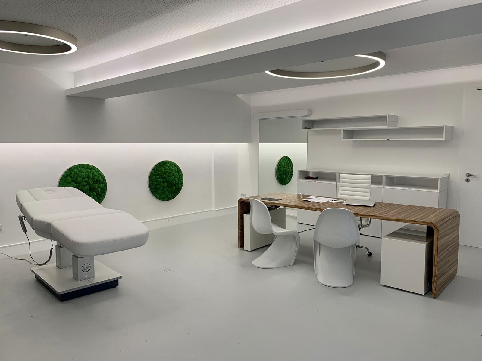 Das Beratungszimmer wird in einem anderen Blickwinkel fotografiert, das den Schreibtisch und den Patientenstuhl zeigt.