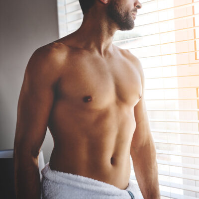 Cropped shot of a handsome young man standing in a in his bedroom towel at home