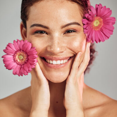 Schöne Frau von Blumen eingerahmt nach einer Baby Botox Behandlung.